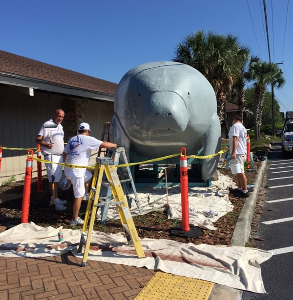 Mike Steve, Charlie Thrasher and another worker from Bud Sasada Painting refurbishing Bubbles the Manatee